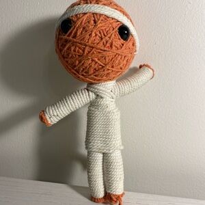 Cute Voodoo doll.  White and orange yarn.